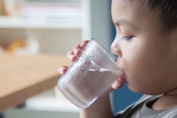 Boy is drinking water in the morning. Boy is drinking water in the morning.